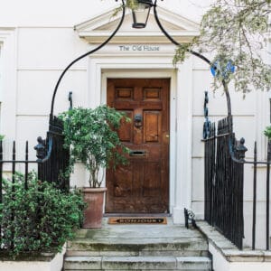 an entrance door with the coir doormat placed in front of the door