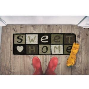 coco doormat in situation with boots and umbrella