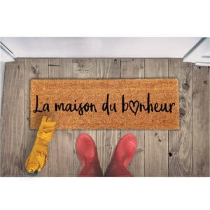 La maison du bonheur doormat on wooden floor with boots and umbrella