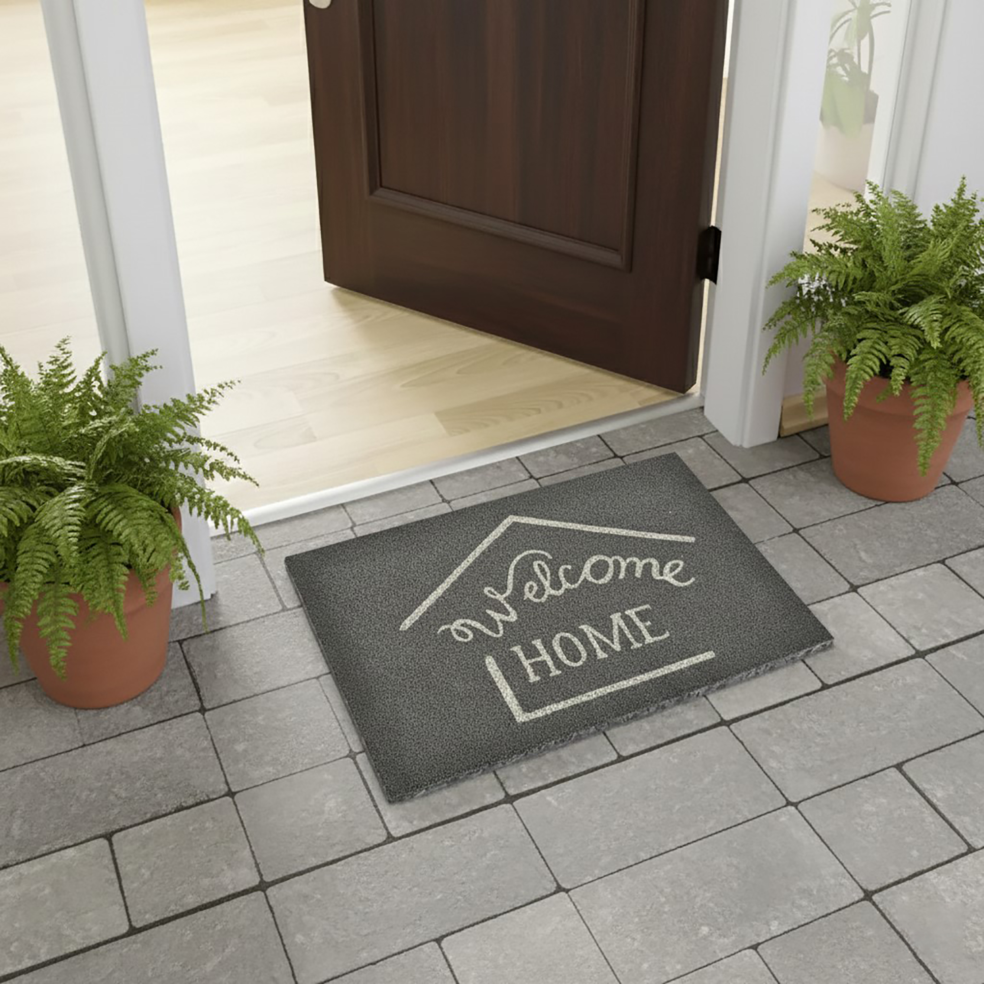 Grey welcome home doormat placed at open door with potted ferns