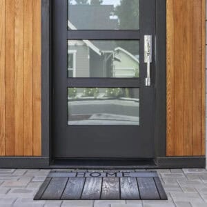 HOME rubber door mat placed in front of modern entry door