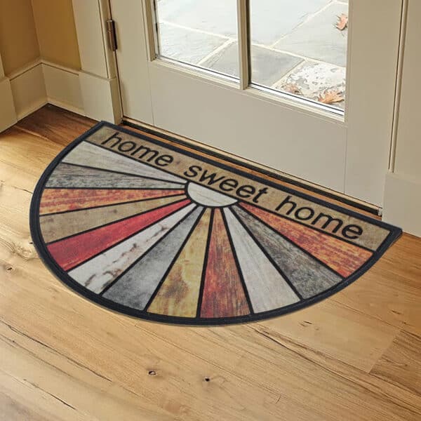 144131040-Home Sweet Home Mat Styled Near Entryway: The radiant "Home Sweet Home" doormat placed inside a modern home near a glass-paned door.