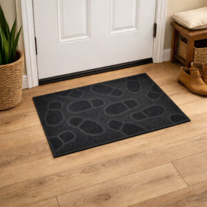 Black rubber entry mat placed indoors on wood floor