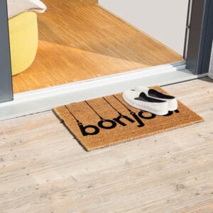 printed coco mat on the floor in front of outside door