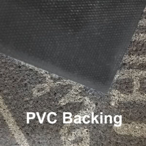 Close-up view of grey doormat showing textured PVC backing