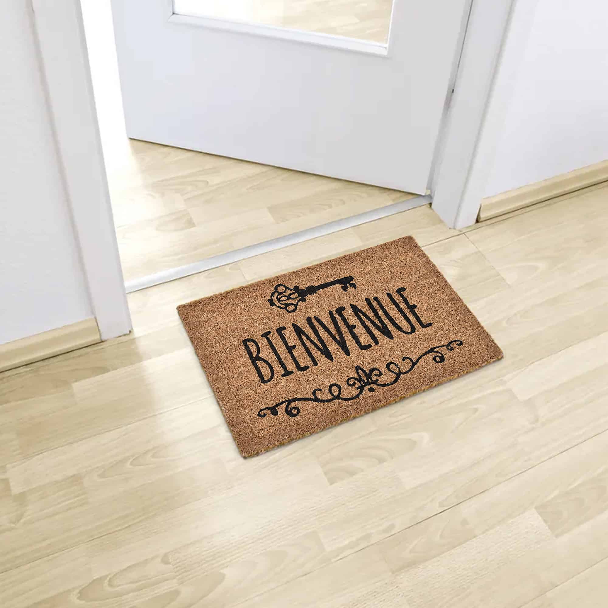 Bienvenue coir doormat placed inside entry on light wood flooring