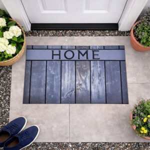 Top view of HOME welcome mat with plants at entrance