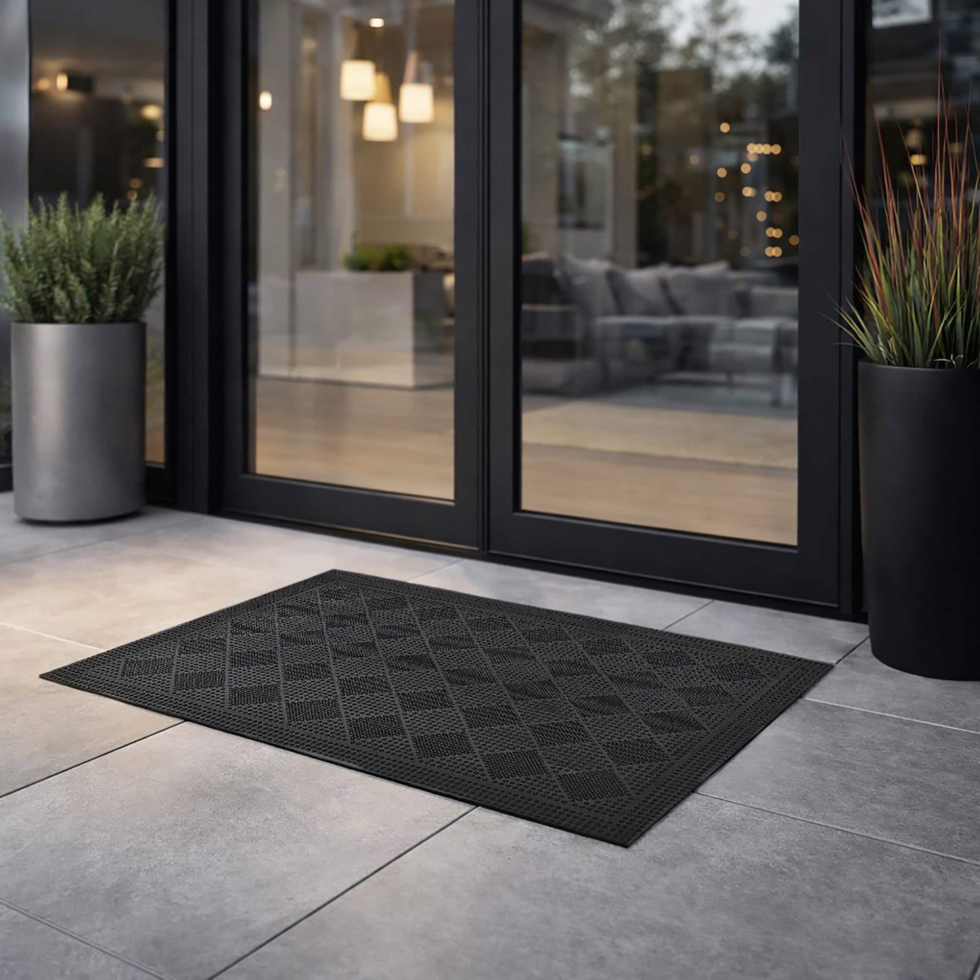 Modern outdoor entrance with black rubber checkerboard door mat