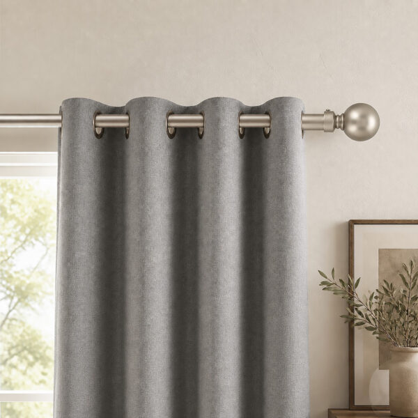 Silver 1-inch curtain rod with ball finial holding gray curtains in a living room window