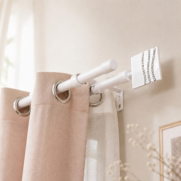 White double curtain rod mounted above a window, blush drape on the front rod and sheer panel on the back rod