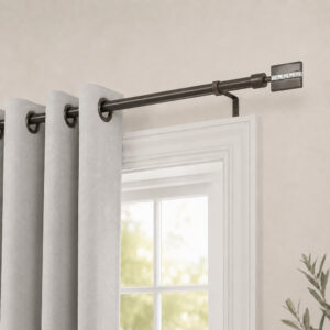 Graphite curtain rod holding grey grommet curtains above a white window frame