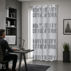 Light gray NYC typography blackout curtain hanging beside a desk in a modern home office