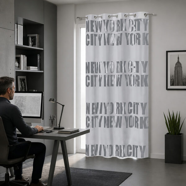 Light gray NYC typography blackout curtain hanging beside a desk in a modern home office