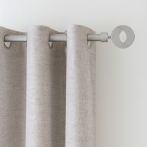 Grey curtain rod with circular finial holding a beige grommet curtain panel on a white wall