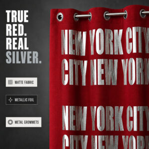 Close up of red matte curtain fabric with silver metallic foil letters and metal grommets