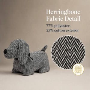 Charcoal dog door stopper on a taupe background with a magnified circle showing the herringbone weave and a weave icon. On-image text: "Herringbone Fabric Detail," "77% polyester, 23% cotton exterior."