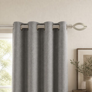 Silver curtain rod with leaf finial holding a grey grommet curtain panel in a living room window