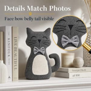 Charcoal cat door stopper on a shelf with books and a candle, a magnifying glass enlarging the face and bow tie. On-image text: "Details Match Photos," "Face bow belly tail visible."