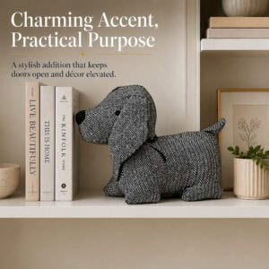 Charcoal dog door stopper on a shelf beside books, a framed print, and a potted plant. On-image text: "Charming Accent, Practical Purpose," "A stylish addition that keeps doors open and décor elevated."
