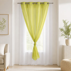 Sunlit room with the lime green and white sheer curtain filtering daylight at the window