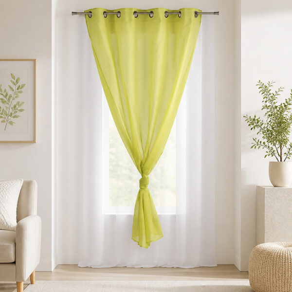 Sunlit room with the lime green and white sheer curtain filtering daylight at the window