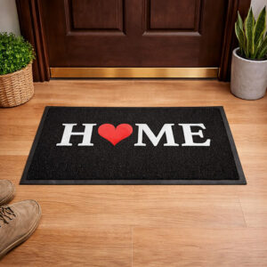 HOME black PVC doormat placed in front of wooden interior door