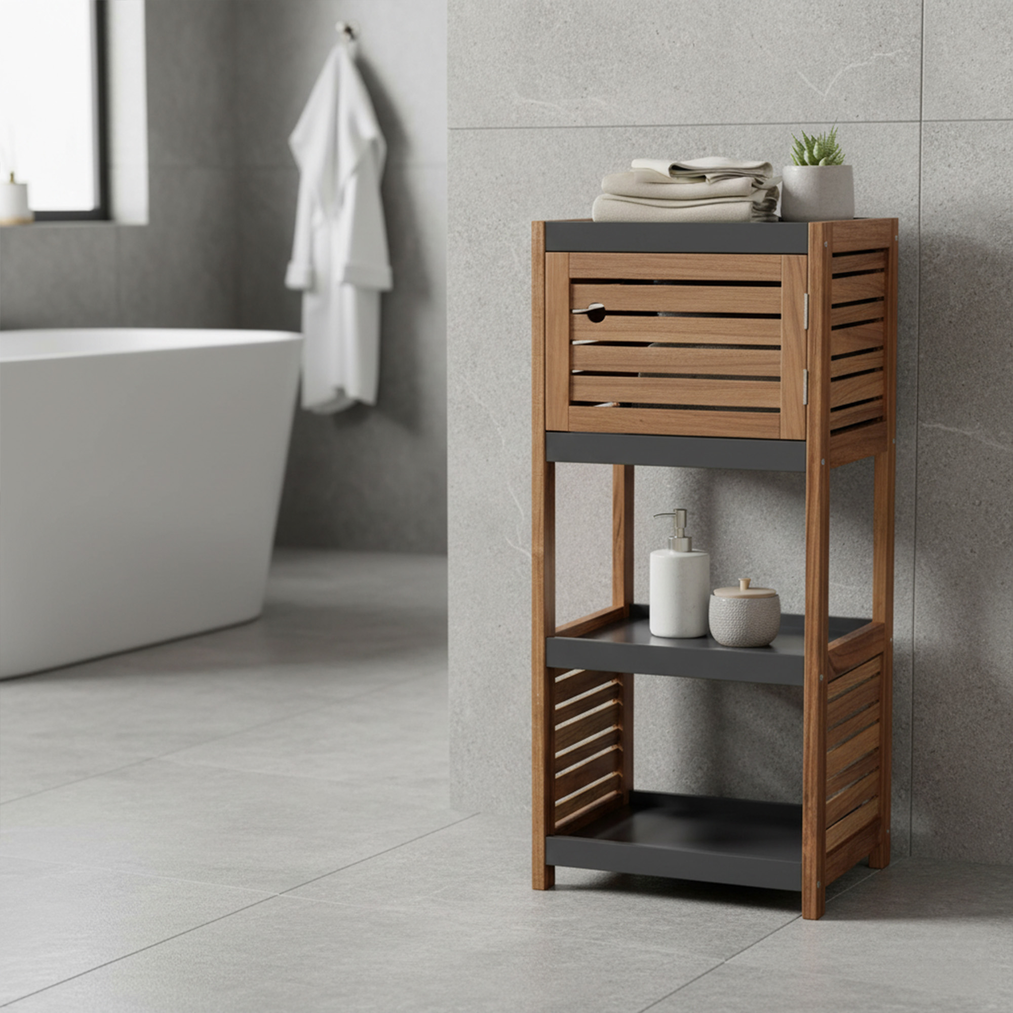 "Acacia wood and grey bathroom storage unit with louvered cabinet door and two open shelves, beside a freestanding bathtub"