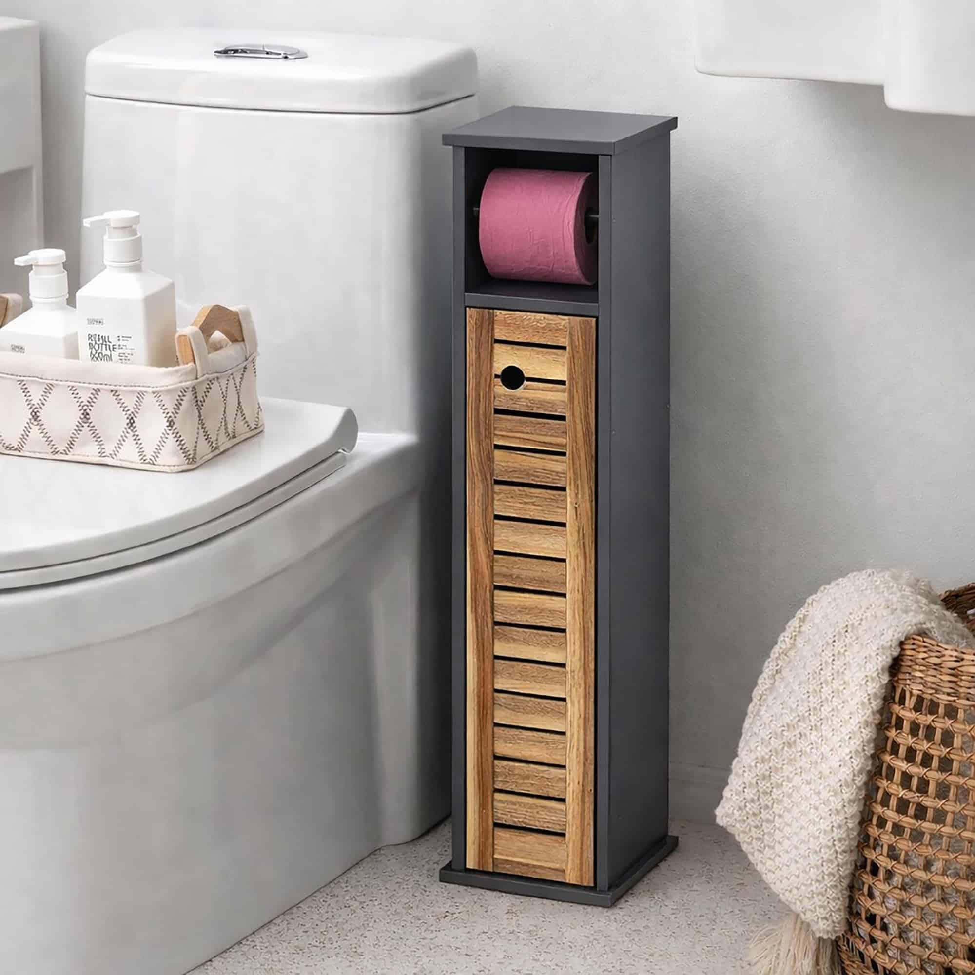 "Dark grey and acacia toilet paper cabinet with pink roll in open holder, placed beside a toilet and bathtub"