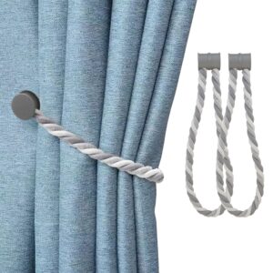 magnetic curtain tiebacks on white background and presentation on blue curtain