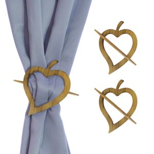 wooden heart tiebacks on white background and presentation on gray curtain