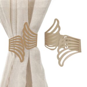 metal wings tieback on white background and presentation on beige curtain