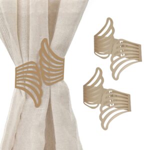 metal wings tiebacks on white background and presentation on beige curtain