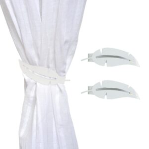 metal feather tiebacks on white curtain