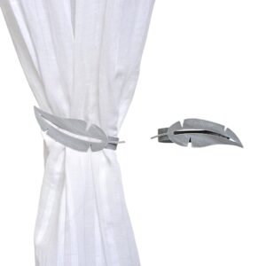 metal feather tieback on white curtain