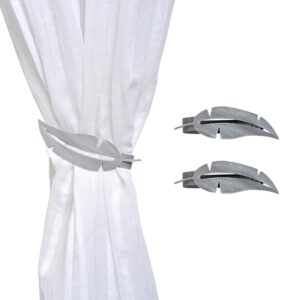 metal feather tiebacks on white curtain