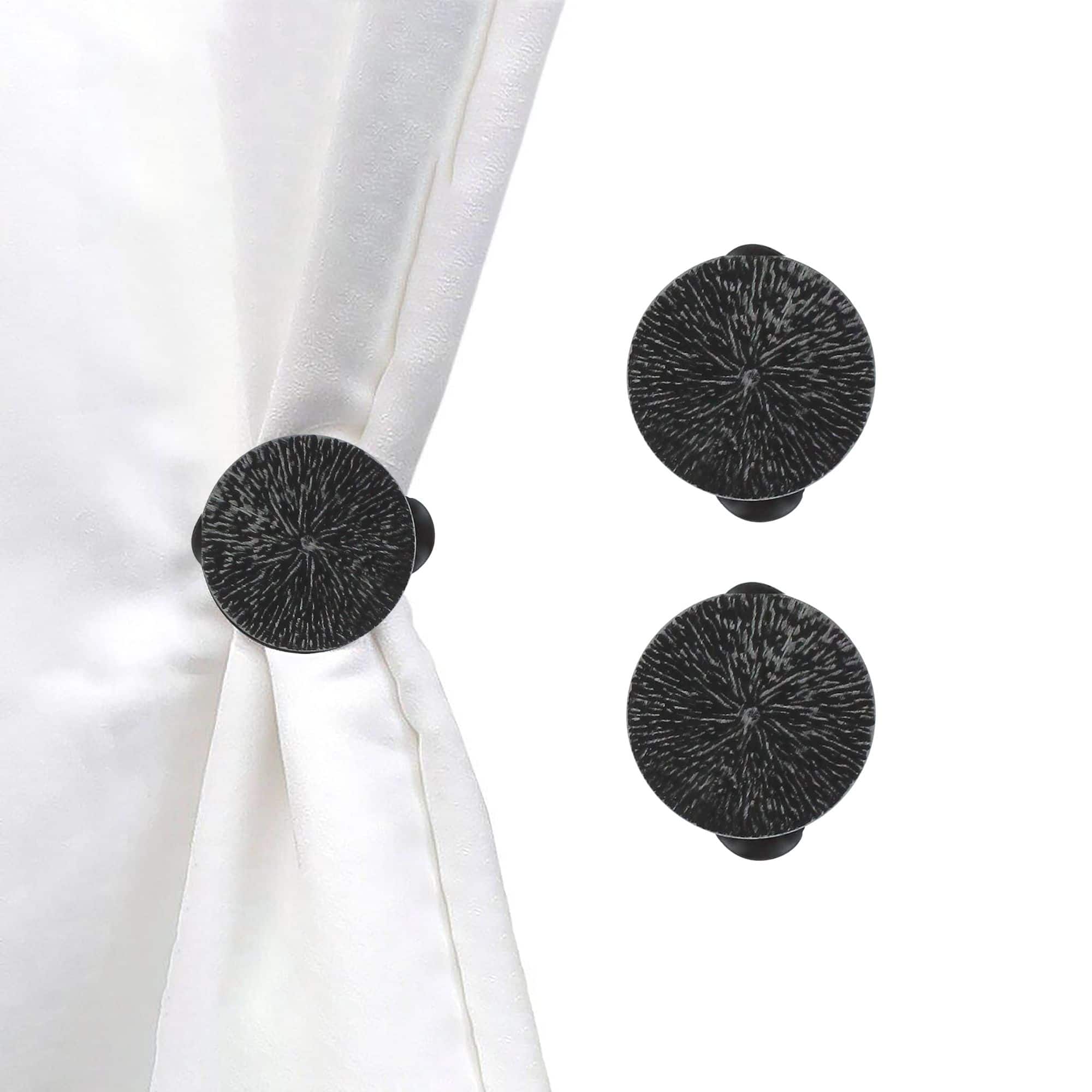 set of 2 black round clips on white background and curtain