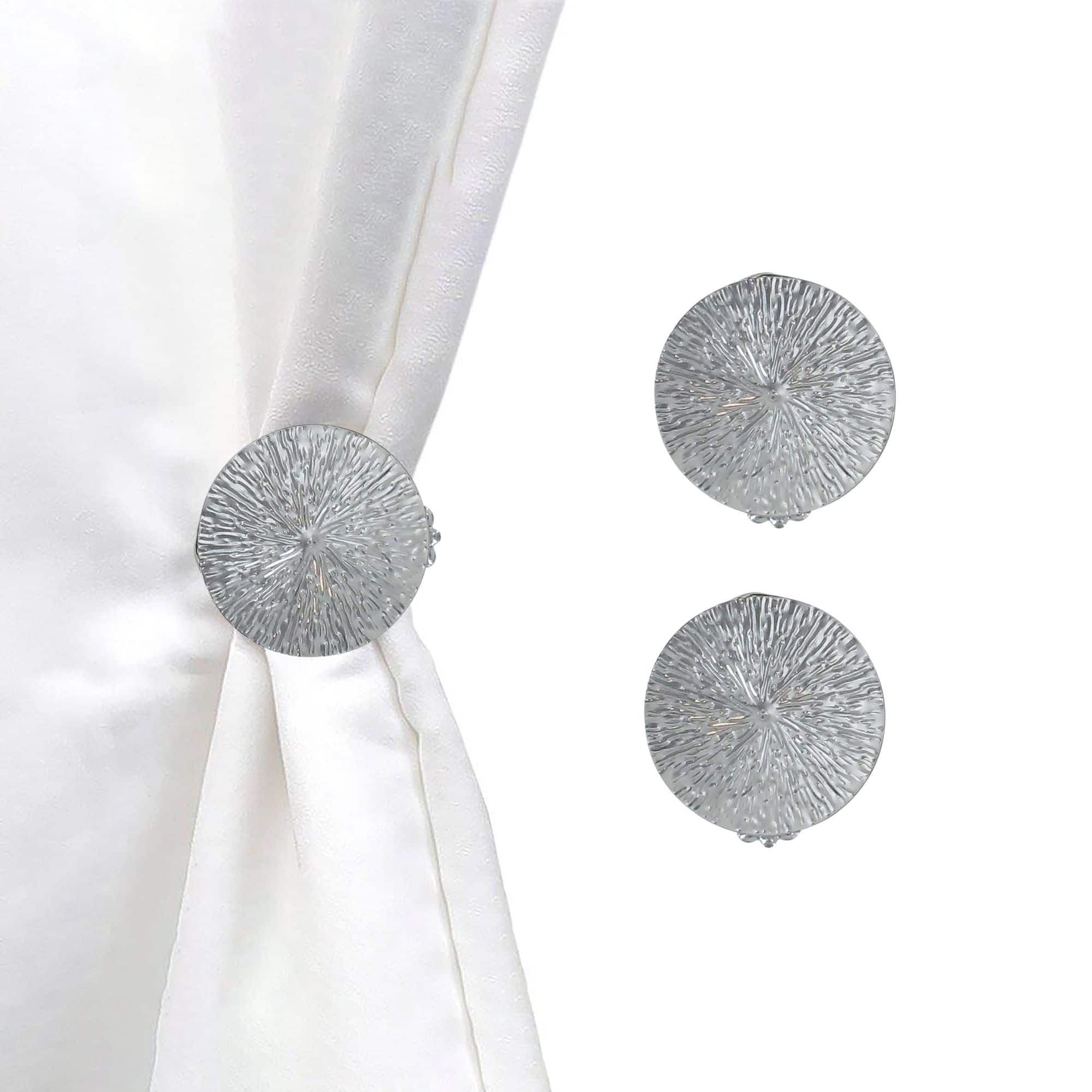 set of 2 chrome round clips on white background and curtain