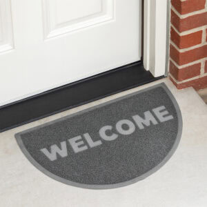 Gray semi circle welcome doormat placed at front door entrance