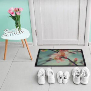 Indoor flower doormat placed by door with shoes on tiled floor