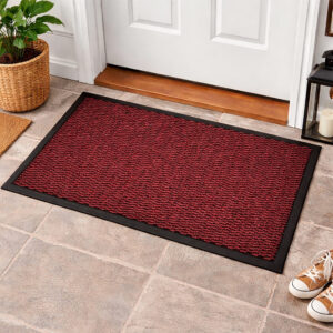 Red indoor door mat placed in front of white entry door on tile floor