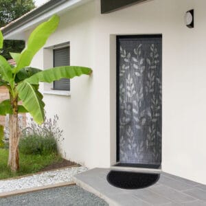 Black half moon doormat placed outside modern front entrance