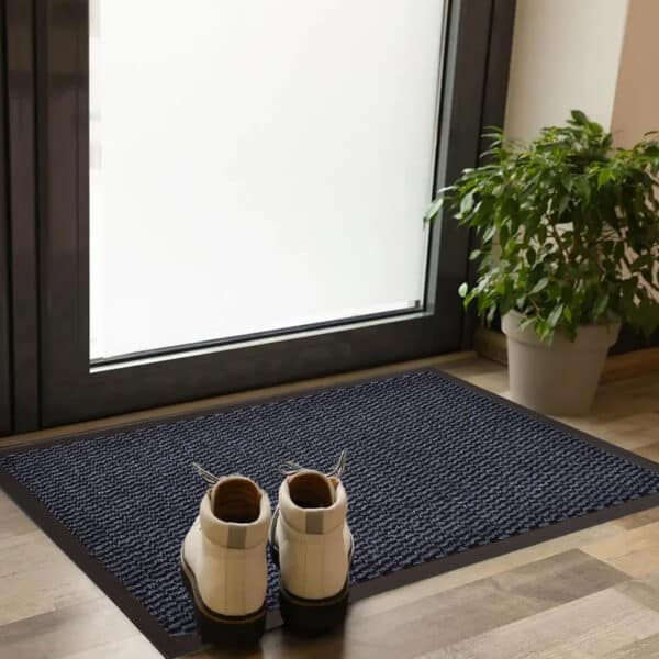 Blue entry door mat with rubber border placed indoors with shoes