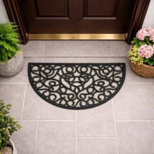 Half round rubber door mat placed in front of a wooden entry door