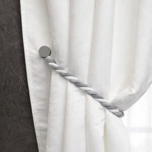 Single gray braided tieback with round magnetic clasp on white curtain