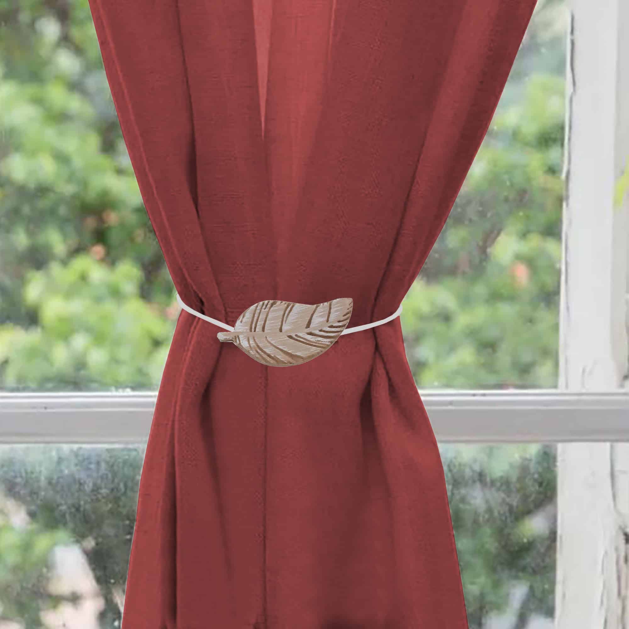 wooden curtain holdback on red curtain