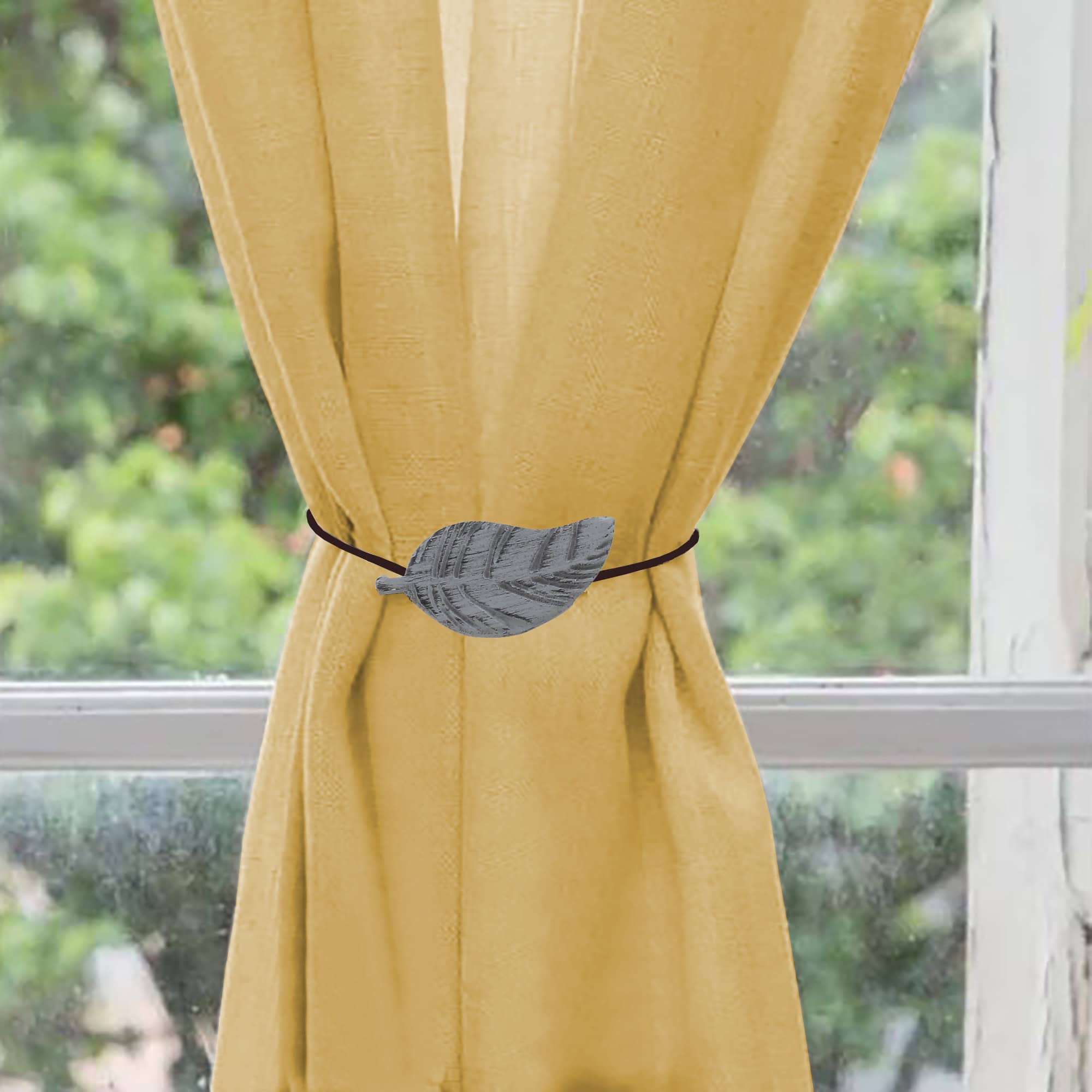 wooden curtain holdback on yellow curtain