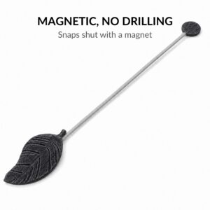 Black leaf curtain tieback laid flat showing magnetic end-cap, no drilling required