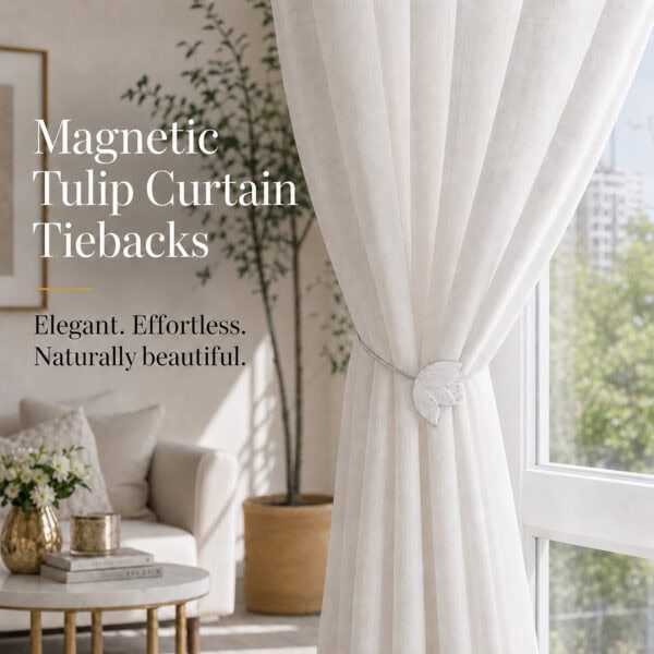 lifestyle: White resin tulip magnetic tieback holding a flowing sheer curtain beside a sunlit window in a bright neutral living room.