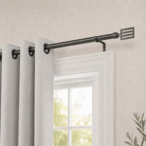 Graphite curtain rod mounted above a window with grey grommet curtains in a bedroom