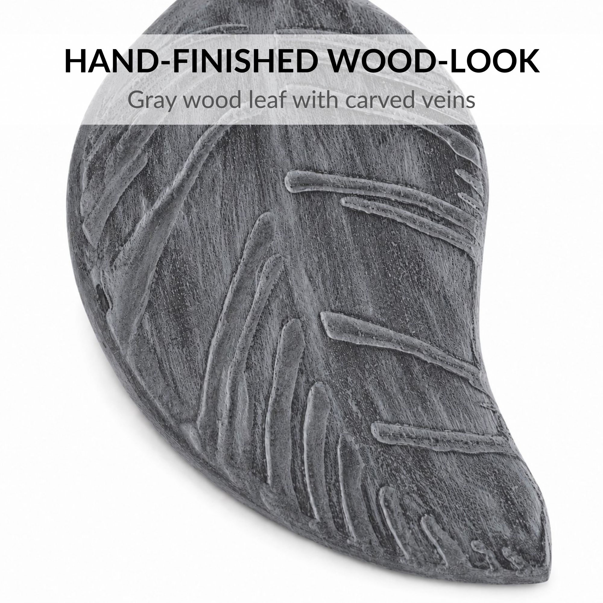 Close-up of gray brushed wood-look leaf tieback with carved veins and brushed finish